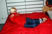 Nina tied and gagged in shiny nylon rainwear