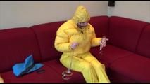 Jill ties, gagges and hoodes herself wearing a shiny yellow down jacket and a yellow rain pants(Video)