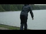 Enni wearing shiny nylon shorts and a rain jacket as well as a rain pants over the shorts (Video)