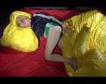Sexy Sonja wearing a green shiny nylon shorts and a black rain jacket lolling in shiny nylon linen (Video)