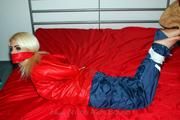Nina tied and gagged in shiny nylon rainwear