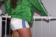 Petra tied and gagged in white shorts and a green cagoule