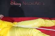 Watching sexy Pia being tied and gagged with ropes on a bed and a clothgag wearing sexy yellow shiny nylon rainwear (Pics)