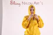 Watching sexy Jill wearing a sexy yellow shiny nylon rainwearcombination and a red shiny nylon raincoat posing for you (Pics)