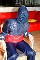 Katharina tied and gagged in a shiny nylon rainsuit