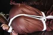 Watching sexy Sonja being tied and gagged on a bed with ropes and a clothgag wearing a supersexy shiny brown nylon pants and a brown rain jacket (Pics)