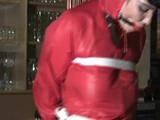 one of our archive girl tied and gagged in a shiny nylon rainsuit
