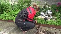 Watching sexy Sandra wearing sexy shiny nylon rainwear gardening outside (Video)
