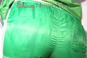 Sonja oiling and rinsing herself in the shower wearing a supersexy green shiny nylon shorts and rain jacket (Pics)