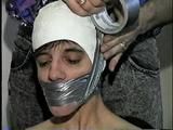 26 Yr OLD K-MART CLERK WRAP TAPE GAGGED WEARING BATHING CAP, MOUTH STUFFED. TIT TIED, CROTCH ROPED, NUDE, GARTER BELT & NYLON STOCKINGS TIGHTLY TIED TO A CHAIR (D63-13)