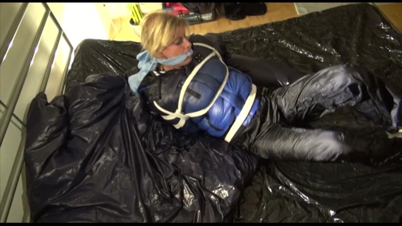 Pia Tied, Gagged And Hooded Lying On A Bed With Shiny Nylon Cloth Wearing A Sexy Black Adidas Nylon Pants And A Blue Down Jacket(Video)