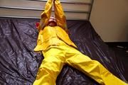 Pia tied and gagged in a shiny nylon rainsuit 
