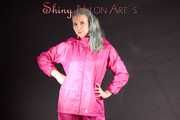 Mara wearing a sexy pink rainsuit posing infront of the camera in a studio (Pics)