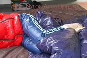 Mara tied and gagged on bed wearing a sexy shiny red down jacket and a blue rain pants (Pics)