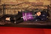 Mara tied and gagged on a princess bed in an old cellar wearing an supersexy shiny purple down jacket and a rain pants (Pics)
