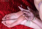 Barefoot topless Tracy in only panties, balltied with hemp rope, wiggles on the bed