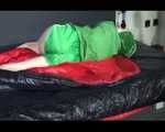 Lucy wearing a green shiny nylon shorts and a green rain jacket lolling on bed (Video)