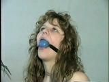 19 Yr OLD SINGLE MOM RONI IS WRAP CLEAVE GAGGED WITH AN ACE BANDAGE, HANDGAGGED, MOUTH STUFFED, BALL-GAGGED & TIED BACKWARDS TO A CHAIR (D53-9)