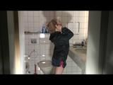 Blonde archive girl posing on a blowable chair wearing shiny nylon shorts and a rain jacket (Video)
