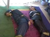 Two archive girls tied and gagged with tape on the floor wearing shiny nylon rainwear (Video)