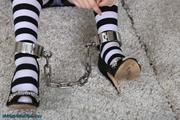 Prisoner cuffed in heavy cuffs