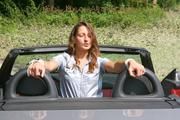 Stella tied and gagged in a grey shiny nylon catsuit in a car