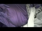 A video with Alina tied and gagged in a shiny purple and silver PVC suit