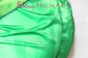 Sonja oiling and rinsing herself in the shower wearing a supersexy green shiny nylon shorts and rain jacket (Pics)