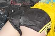Lucy wearing a sexy black/yellow shiny nylon shorts and a yellow rain jacket preparing her sofa with a special cloth to enjoy it (Pics)