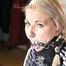 Mara tied and gagged on bed with cuffs wearing a sexy black rainwear jumpsuit (Pics)