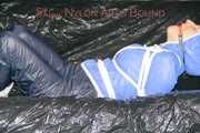 ***SEXY SANDRA*** wearing a supersexy skinny shiny nylon pants and a lightblue shiny nylon rain jacket being bound on a sofa with ropes and a ball gag (Pics)