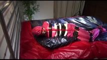Lulu tied, gagged and hooded on a bed wearing sexy rainwear combination (Video)