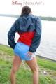 Sexy archive girl walking on a lake wearing a sexy shiny nylon shorts and an oldschool rain jacket (Pics)