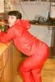 Jill posing sexy in an bar wearing sexy red shiny nylon rainwear (Pics)