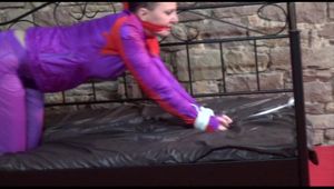 Mara tied and gagged on a princess bed in an old cellar wearing a sexy purple rainwear combination (Video)
