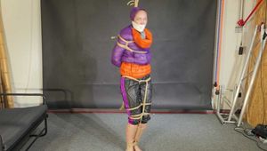 Rachel Adams bound, gagged and double hooded in shiny downjackets
