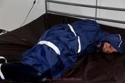 Simone tied and gagged in a shiny nylon rainsuit and a shiny nylon cape