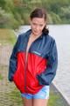 Sexy archive girl walking on a lake wearing a sexy shiny nylon shorts and an oldschool rain jacket (Pics)