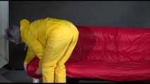 Watching Mara putting on sexy yellow shiny nylon rainwear lolling on the sofa (Video)
