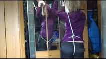 Pia tied with ropes overhead and gagged with a ballgag wearing sexy rain pants and a rain jacket (Video)