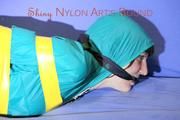 Mara tied and gagged with tape on a sofa wearing a supersexy shiny blue rain pants and a grren rain jacket (Pics) 