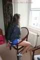Stella being tied and gagged with ropes and a clothgag on a chair wearing a sexy shiny nylon short and a rain jacket (Pics)