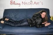 Petra lolling on the sofa wearing a sexy blue rainwear combination (Pics)