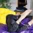 Pia wearing a sexy black rain pants and a yellow down jacket tied on bed with cuffs and gagged with a cloth (Pics)