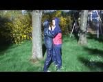 Jill and a friend of her playing with eachother in the garden while wearing shiny nylon rainwear (Video)