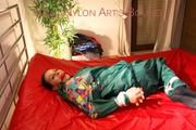 Lucy tied and gagged on bed wearing a sexy green rainwear combination (Pics)