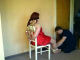 Lady in Red on a chair 1/2