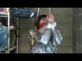 a video with Nicole tied and gagged in a shiny silver PVC sauna suit