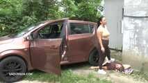 Mistress Jenna stands on the slave with a car while smoking in the slave's mouth A