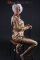 Blonde archive girl posing in a studio wearing a sexy golden rainwear combination (Pics)